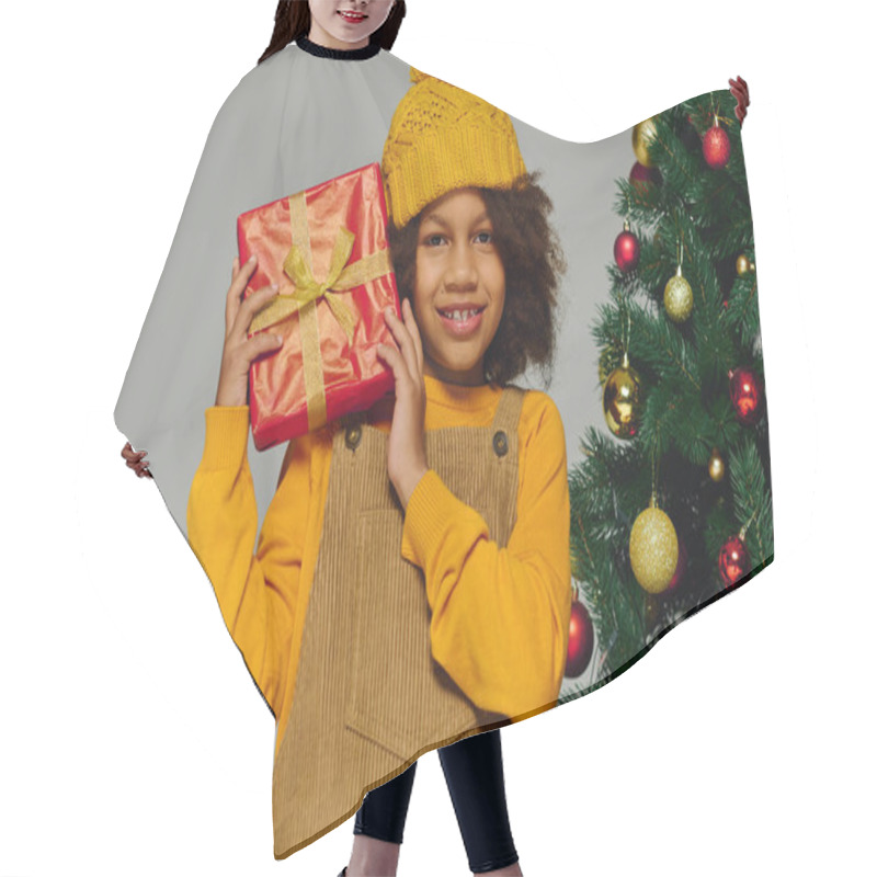 Personality  A Girl Beams With Joy, Holding A Gift By A Decorated Christmas Tree. Hair Cutting Cape