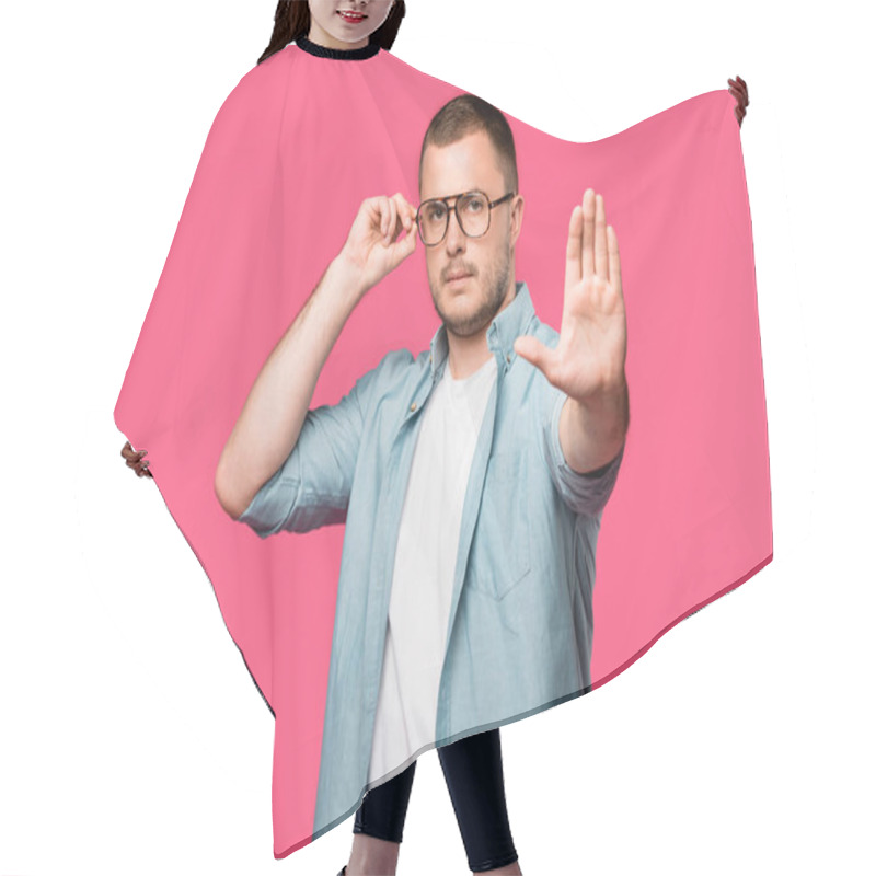 Personality  Serious Man Adjusting Eyeglasses And Showing No Sign Isolated On Pink Hair Cutting Cape