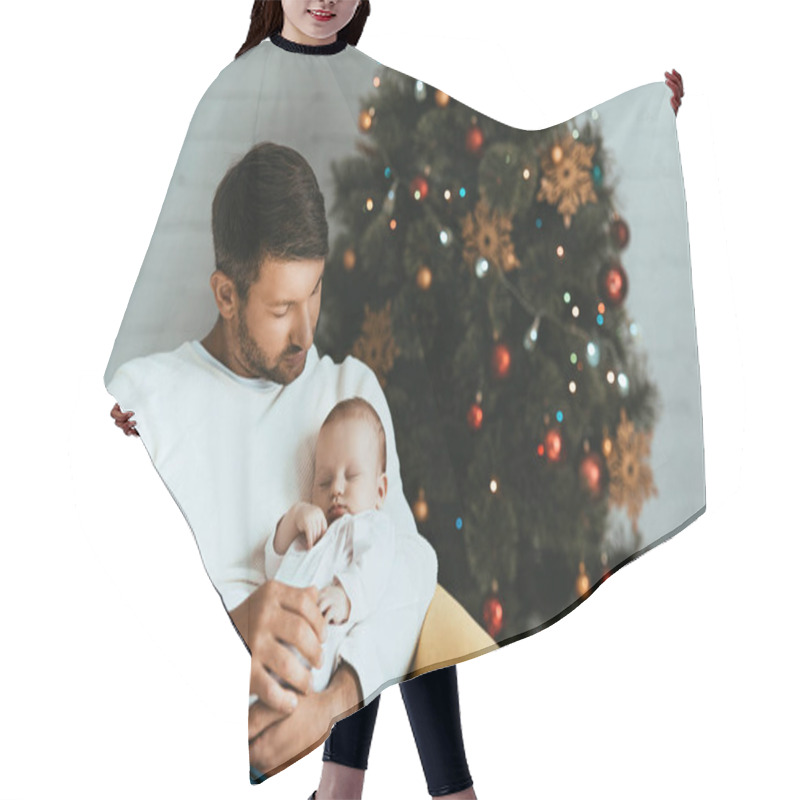 Personality  Happy Father Holding Sleeping Baby While Sitting Near Christmas Tree Hair Cutting Cape