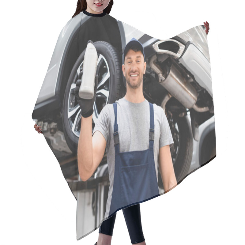 Personality  Low Angle View Of Happy Mechanic In Cap Holding Bottle With Car Oil  Hair Cutting Cape