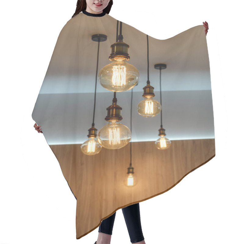 Personality  Close-up View Of Illuminated Light Bulbs Hanging In Empty Room Hair Cutting Cape