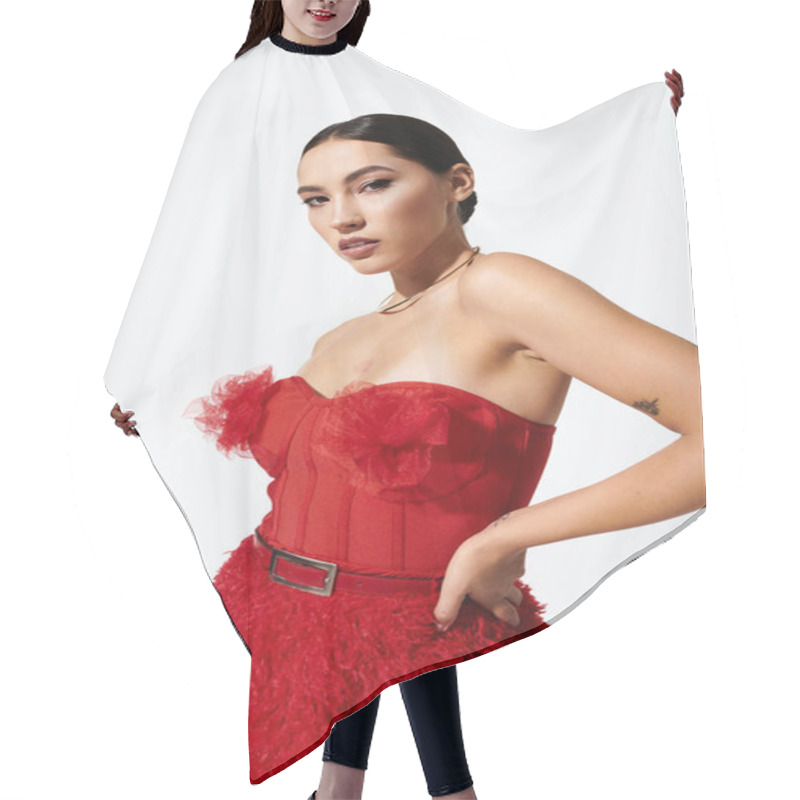 Personality  The Young Woman Poses Confidently In A Striking Red Dress Adorned With Delicate Ruffles. Hair Cutting Cape