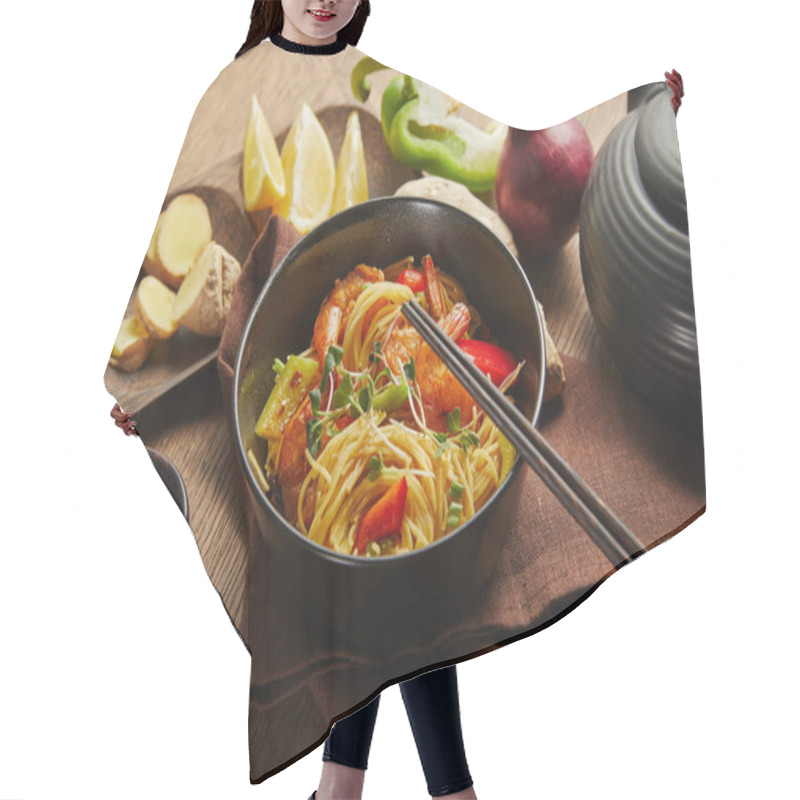 Personality  Noodles With Shrimps And Vegetables In Bowl Near Chopsticks, Soy Sauce, Lemon And Ginger Root, Teapot On Napkin On Wooden Table Hair Cutting Cape