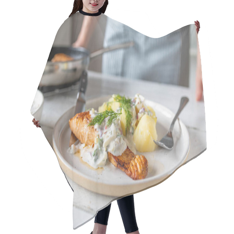 Personality  Pan Fried Salmon Fillet With Light Yogurt Apple Dill Sauce And Boiled Potatoes On A Plate On Kitchen Table Hair Cutting Cape