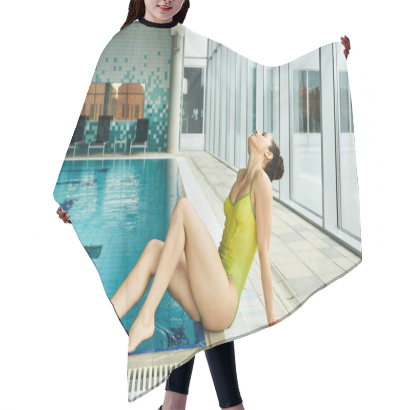 Personality  A Brunette Woman In A Yellow Bathing Suit Lounging On The Edge Of An Indoor Swimming Pool. Hair Cutting Cape