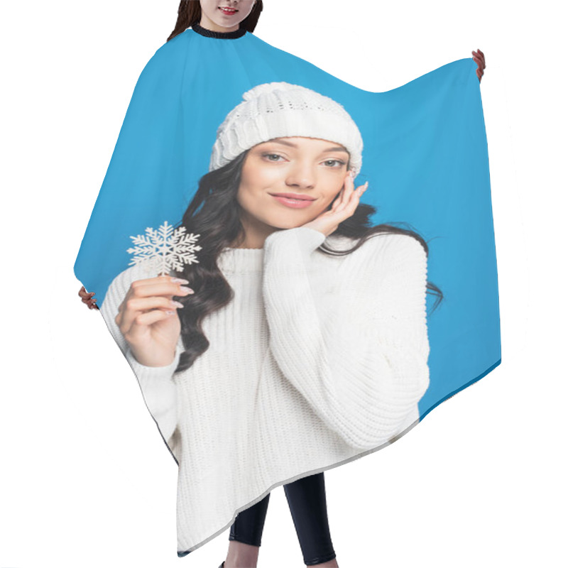 Personality  Pleased Woman In Knitted Hat Holding Decorative Snowflake Isolated On Blue Hair Cutting Cape