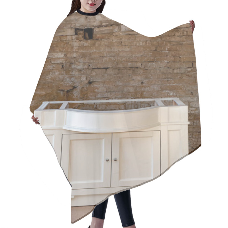 Personality  Bathroom Vanity Cabinet For Two Washbasins Against The Old Brick Wall Background. Close-up Hair Cutting Cape