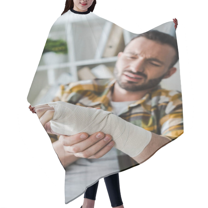 Personality  Selective Focus Of Injured Arm Of Bearded Man Suffering From Pain  Hair Cutting Cape