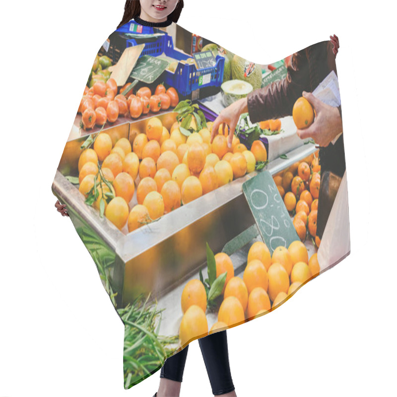 Personality  Valencia, Spain - February 2, 2019: Woman Picking Oranges From A Fruit Stall In A Market . Hair Cutting Cape