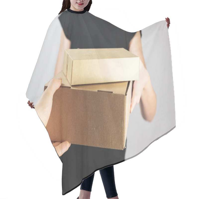 Personality  Taking Or Giving Boxes With Goods. Delivery, Postal Service Or Mailman Concept: Giving Package From Hand To Hand Hair Cutting Cape