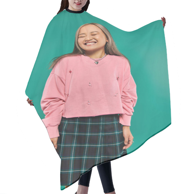 Personality  Portrait Of Pleased And Young Asian Girl In Pink Sweatshirt Posing On Turquoise Background Hair Cutting Cape