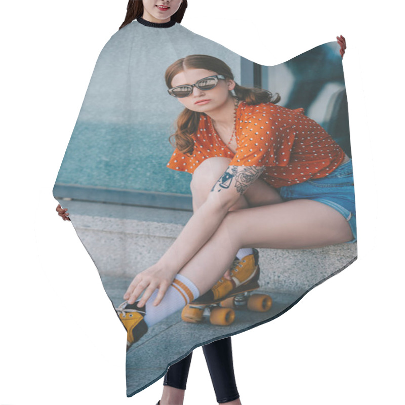 Personality  Girl In Sunglasses Looking At Camera While Sitting In Street And Wearing Vintage Roller Skates Hair Cutting Cape