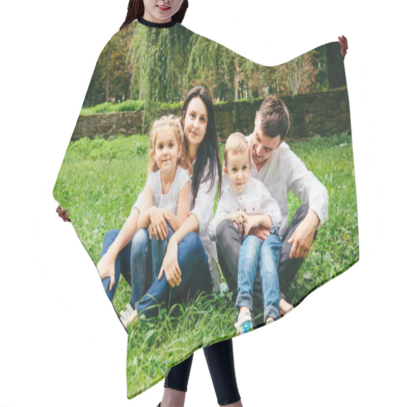 Personality  Portrait Of Happy Family Mother, Father, Duaghter And Son Sit On The Ground Hair Cutting Cape