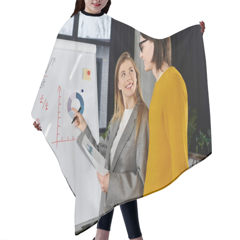 Personality  Two Young And Chic Individuals Engage In A Lively Discussion While Analyzing Data On A Whiteboard. Hair Cutting Cape