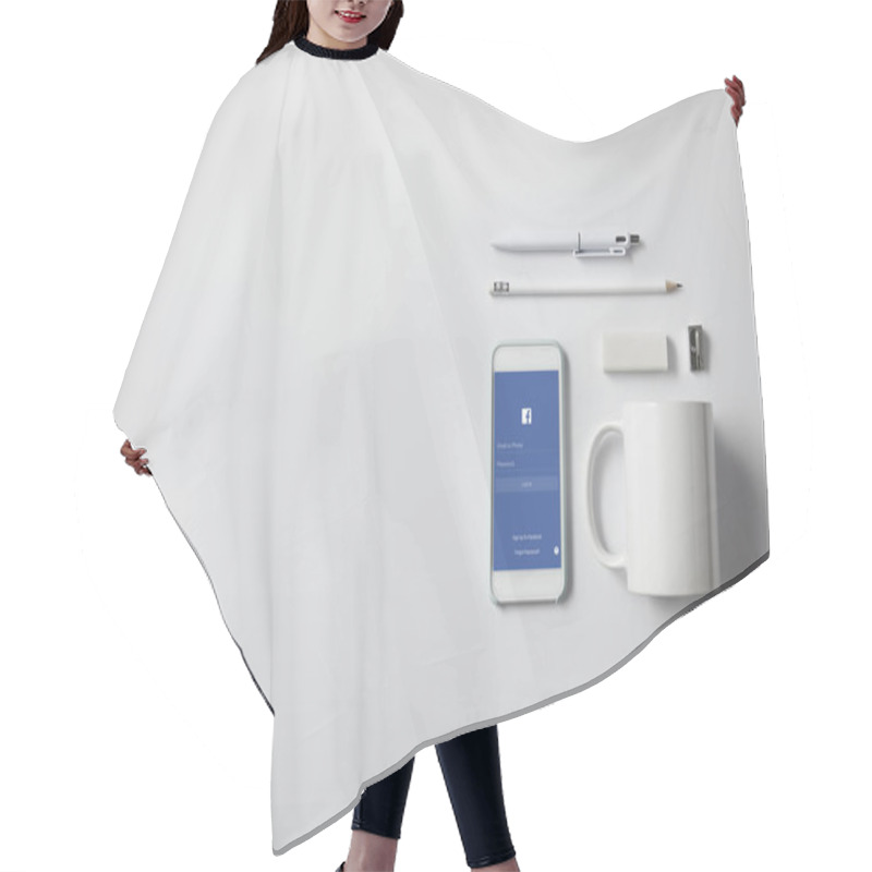 Personality  Top View Of Smartphone With Facebook App And Various Supplies On White Tabletop Hair Cutting Cape