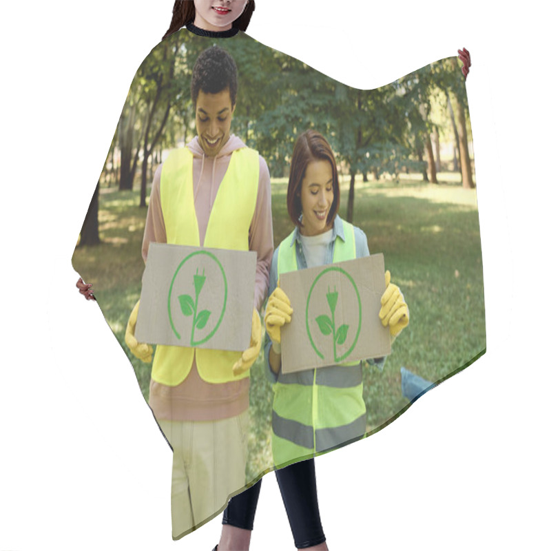 Personality  Diverse, Socially Active Couple In Safety Vests And Gloves Holding Signs While Cleaning A Park Together. Hair Cutting Cape