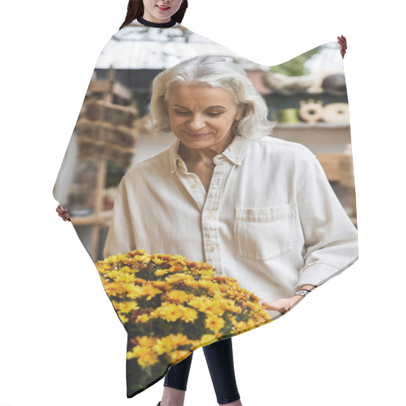 Personality  A Beautiful Mature Woman Carefully Tends To A Bouquet Of Cheerful Yellow Flowers In A Garden Shop. Hair Cutting Cape