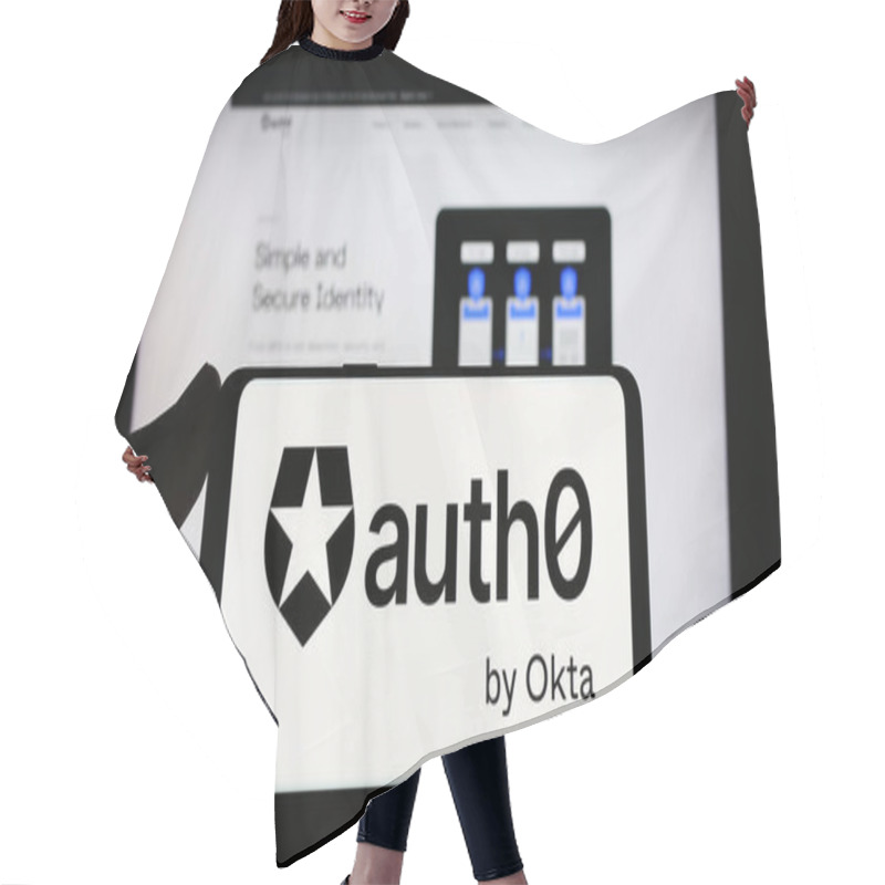 Personality  Stuttgart, Germany - 08-20-2023: Person Holding Smartphone With Logo Of US Identity Platform Company Auth0 By Okta On Screen In Front Of Website. Focus On Phone Display. Hair Cutting Cape