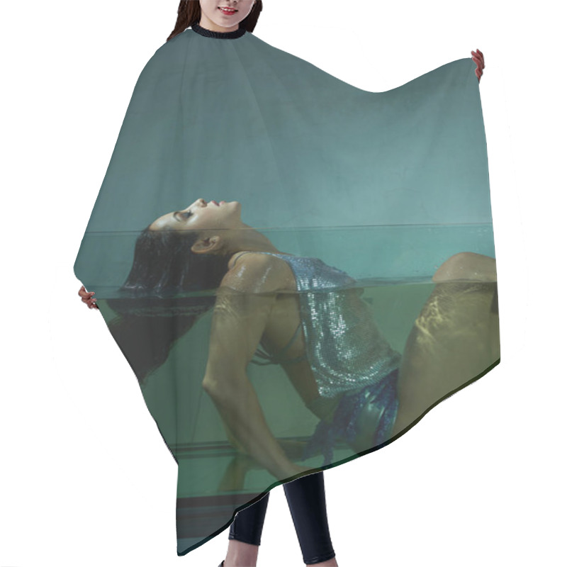 Personality  A Young Woman With Wet Brunette Hair Floats In An Aquarium, Her Body Submerged In The Water, While Wearing A Shimmering Top And Skirt. Hair Cutting Cape