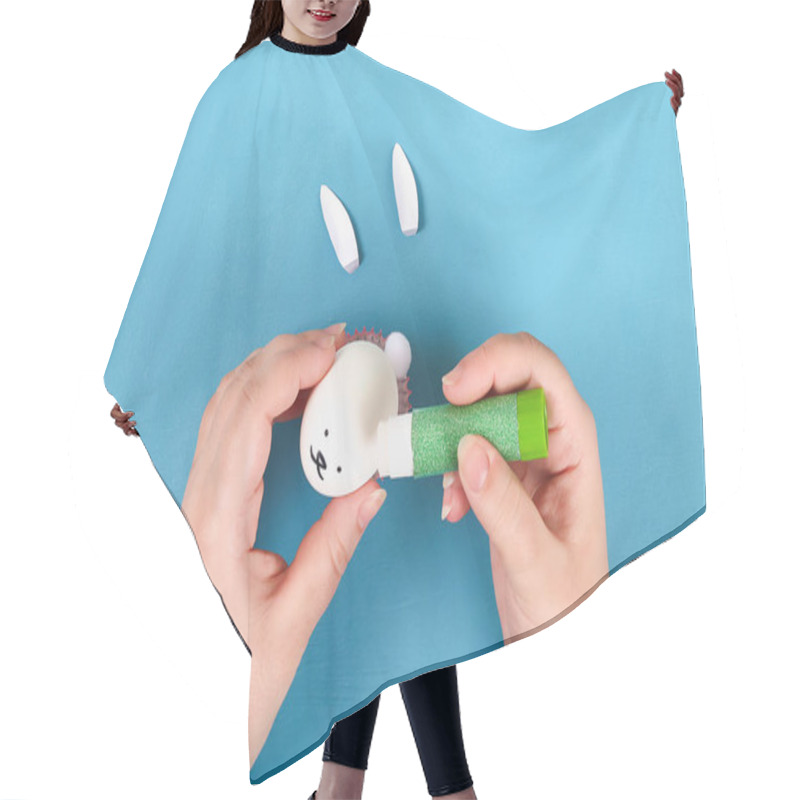 Personality  Diy Rabbit From Easter Eggs On Blue Background. Gift Ideas, Decor Easter, Spring. Handmade. White Easter Egg Bunny, Grass Crepe Paper, Cup Muffin Cupcake. Step By Step. Process Kid Crafts. Top View. Hair Cutting Cape