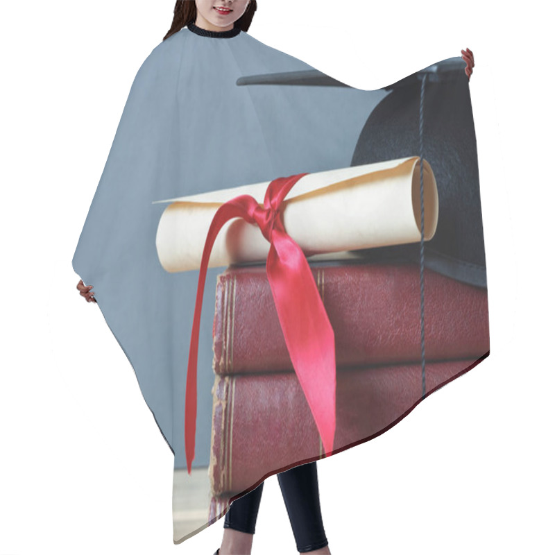 Personality  Close Up Of A Mortarboard And Graduation Scroll On Top Of A Pile Of Old, Worn Books, Placed On A Light Wood Table With A Grey Background. Hair Cutting Cape