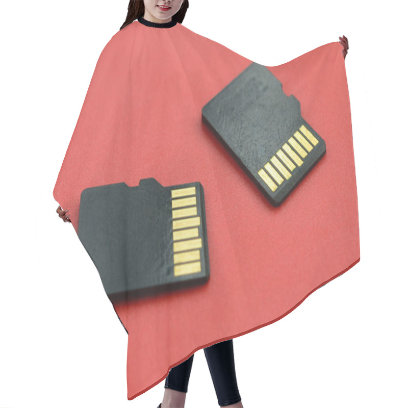 Personality  Two Small Micro SD Memory Cards Lie On A Red Background. A Small And Compact Data And Information Store Hair Cutting Cape