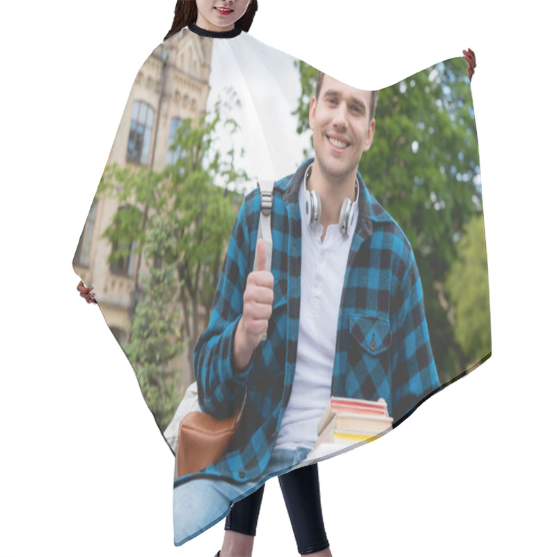 Personality  Cheerful Student Showing Thumb Up And Holding Books  Hair Cutting Cape