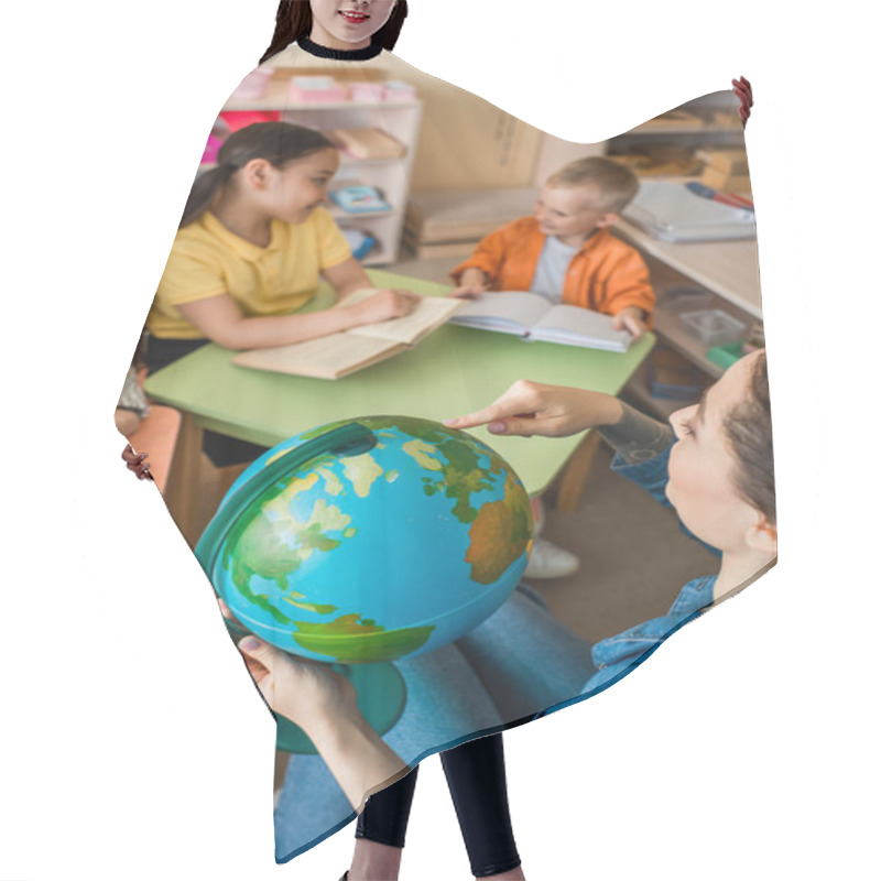 Personality  High Angle View Of Teacher Pointing At Globe Near Multiethnic Kids During Lesson Hair Cutting Cape