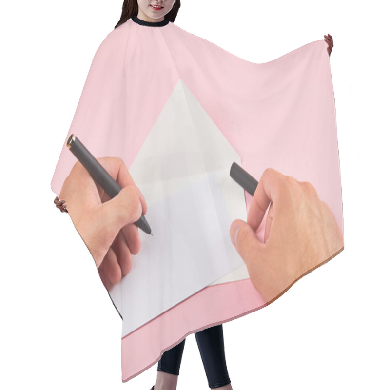 Personality  Cropped View Of Man Writing With Pen On White Empty Card Near Envelope On Pink Background Hair Cutting Cape