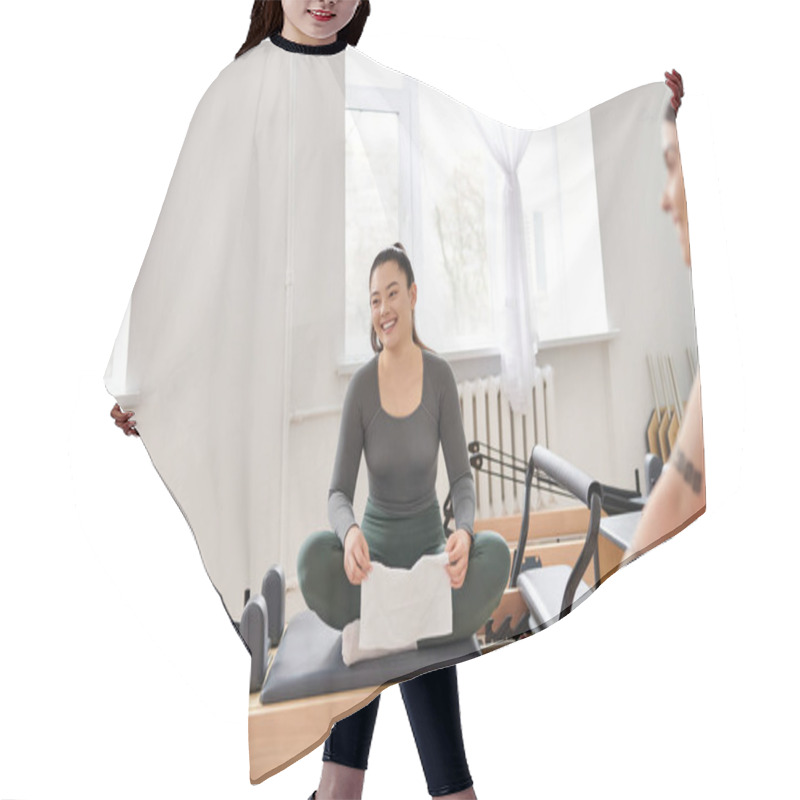 Personality  Attractive Women Taking Break During Pilates Lesson In Gym. Hair Cutting Cape