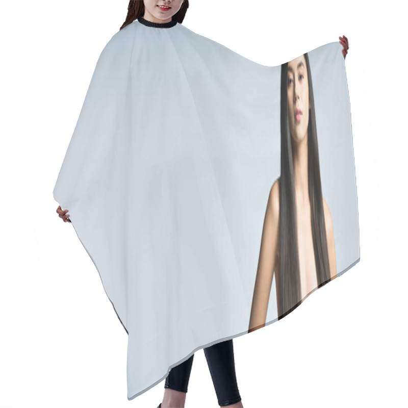 Personality  A Young Woman With Long Black Hair Poses Confidently Against A Light Blue Background. Hair Cutting Cape