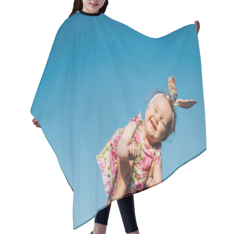 Personality  Baby In Air. Cheerful Child In Blue Sky Background. Infant Girl On Hands Flying In Clouds. Fashion Child With Headwear Hair Cutting Cape