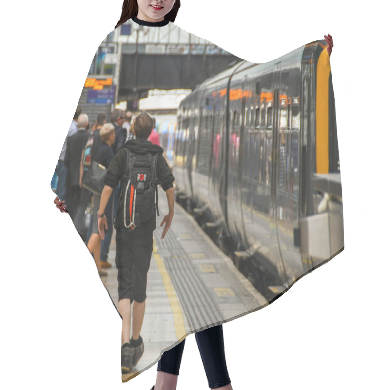 Personality  LONDON, ENGLAND - JULY 2018: Young Rail Passenger With A Rucksack Walking Along A Platform At London Paddington Railway Station To Catch His Train. Hair Cutting Cape