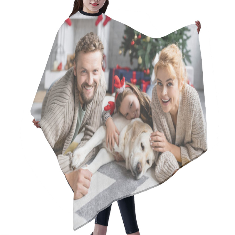 Personality  Cheerful Family Looking At Camera Near Blurred Daughter And Labrador During Christmas At Home  Hair Cutting Cape