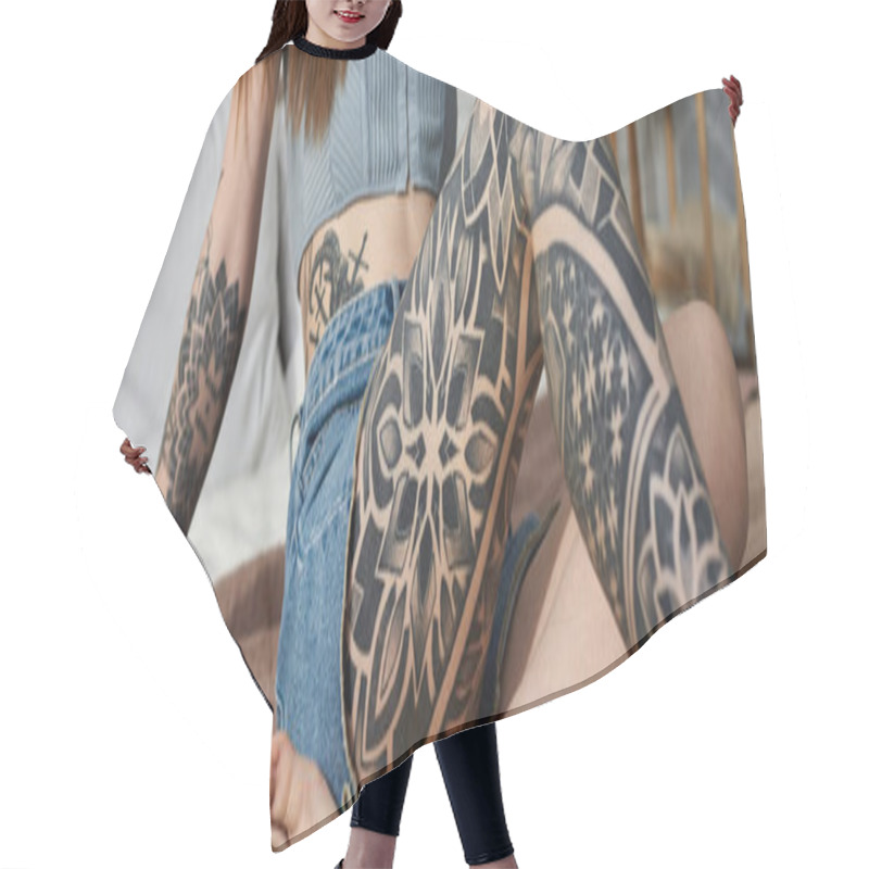 Personality  A Young Woman With Intricate Tattoos On Her Arm And Leg Relaxes On A Bed In A Modern Apartment. Hair Cutting Cape