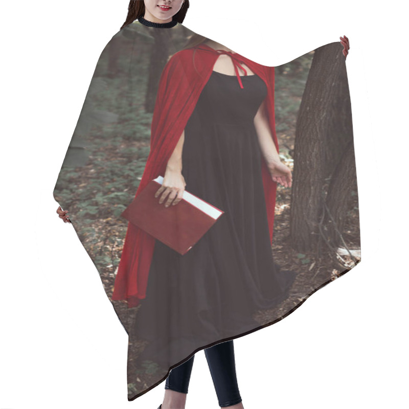 Personality  Cropped View Of Girl In Black Dress And Red Cloak With Magic Book In Forest Hair Cutting Cape