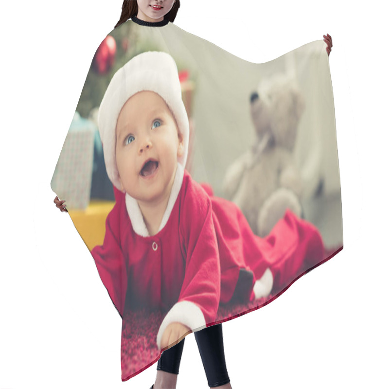 Personality  Close-up Portrait Of Adorable Little Baby In Santa Hat With Blurred Christmas Tree And Gifts On Background And Looking Up Hair Cutting Cape