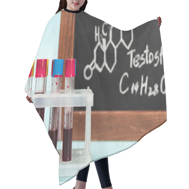 Personality  Selective Focus Of Stand With Blood Samples In Test Tubes Near Blackboard With Testosterone Formula On Blue Background Hair Cutting Cape