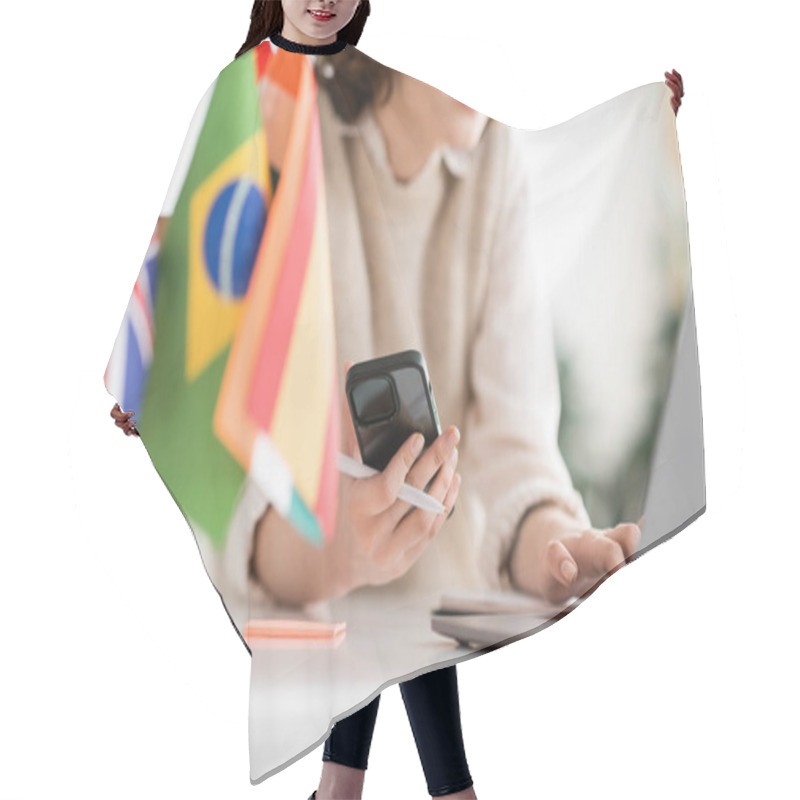 Personality  Cropped View Of Language Teacher Using Mobile Phone Near Laptop And Different Flags On Blurred Foreground  Hair Cutting Cape