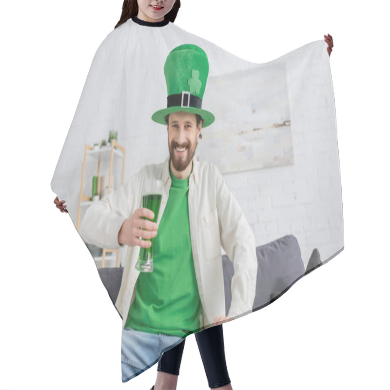 Personality  Smiling Man In Green Hat Holding Beer And Looking At Camera During Saint Patrick Celebration At Home  Hair Cutting Cape