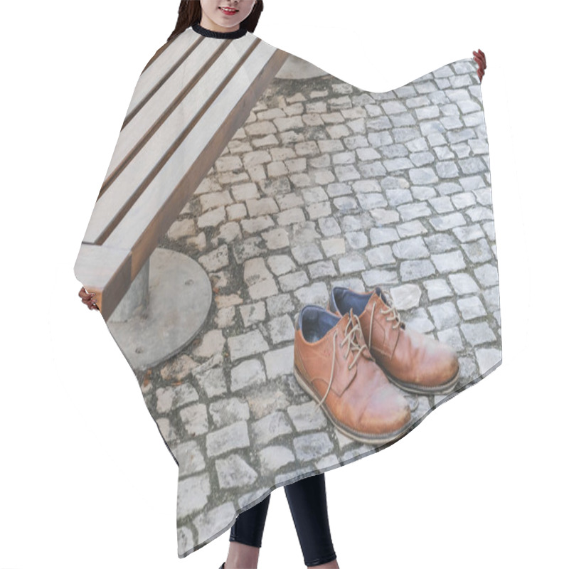 Personality  Brown Leather Shoes On A Cobblestone Pavement Next To A Bench In An Urban Setting. Hair Cutting Cape