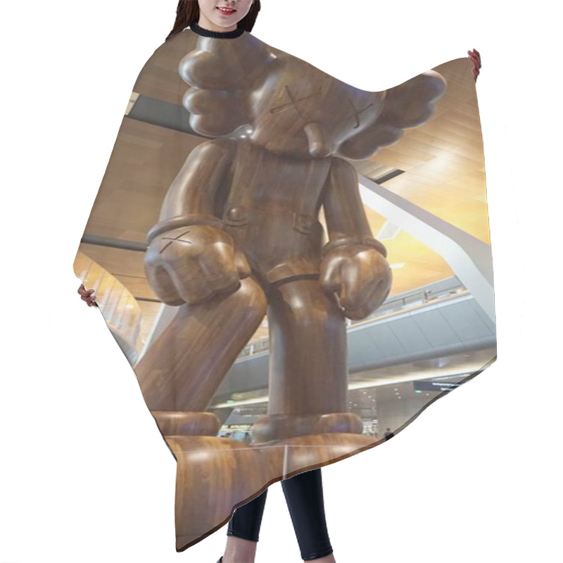 Personality  A Huge Statue Of A Stylized Sad Wooden Man At Doha Hamad Airport In Qatar. Hair Cutting Cape