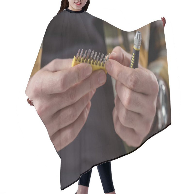 Personality  Cropped Image Of Hands Holding Screwdriver And Its Attachments  Hair Cutting Cape