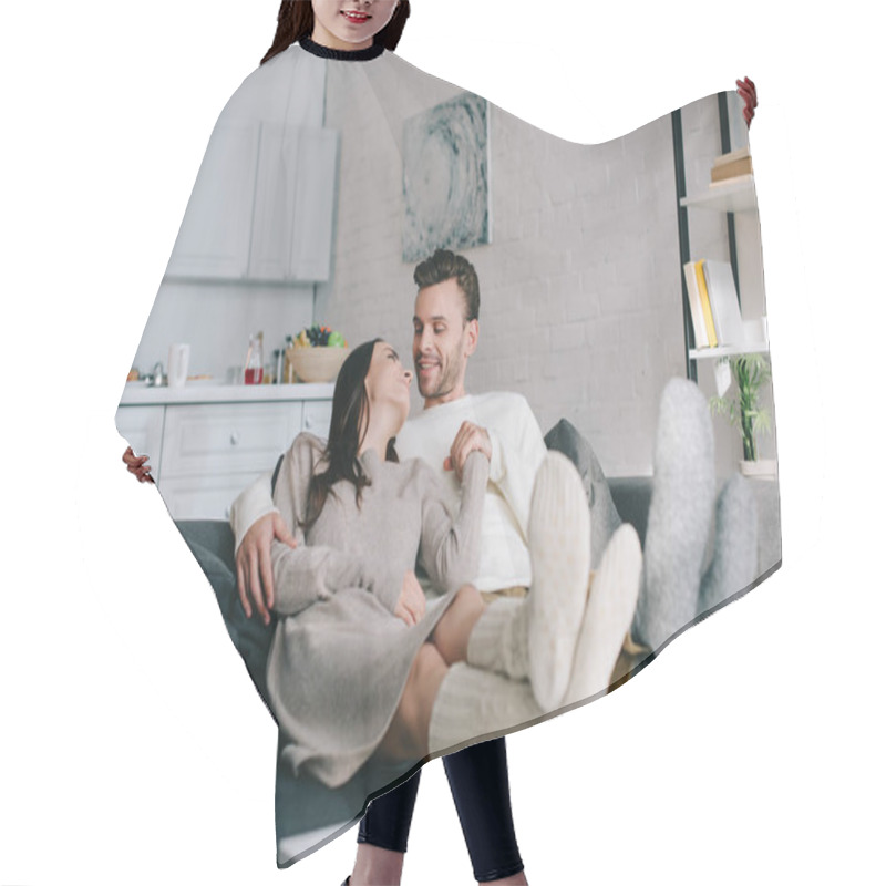 Personality  Happy Couple In Woolen Socks Relaxing On Couch At Home Hair Cutting Cape