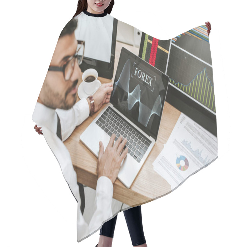 Personality  Selective Focus Of Bi-racial Trader Using Laptop With Forex Letters  Hair Cutting Cape