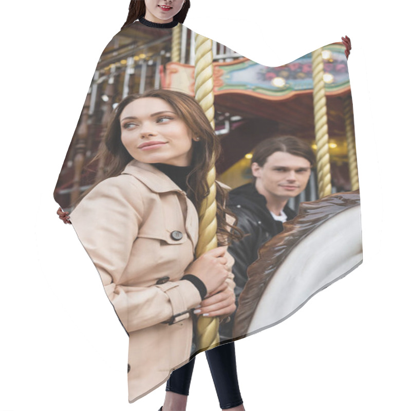 Personality  Pretty Young Woman In Trench Coat Riding Carousel Horse Near Blurred Boyfriend Hair Cutting Cape