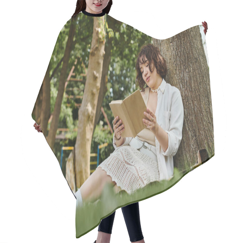 Personality  A Young Woman Enjoys Reading A Book Under A Tree In A Lush Summer Park. Hair Cutting Cape