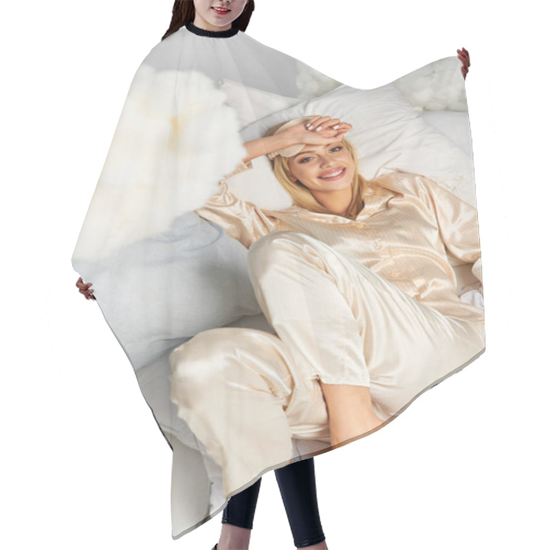 Personality  A Dreamy Blonde Woman In Cozy Pajamas Lays Atop A Bed Next To Pillows. Hair Cutting Cape