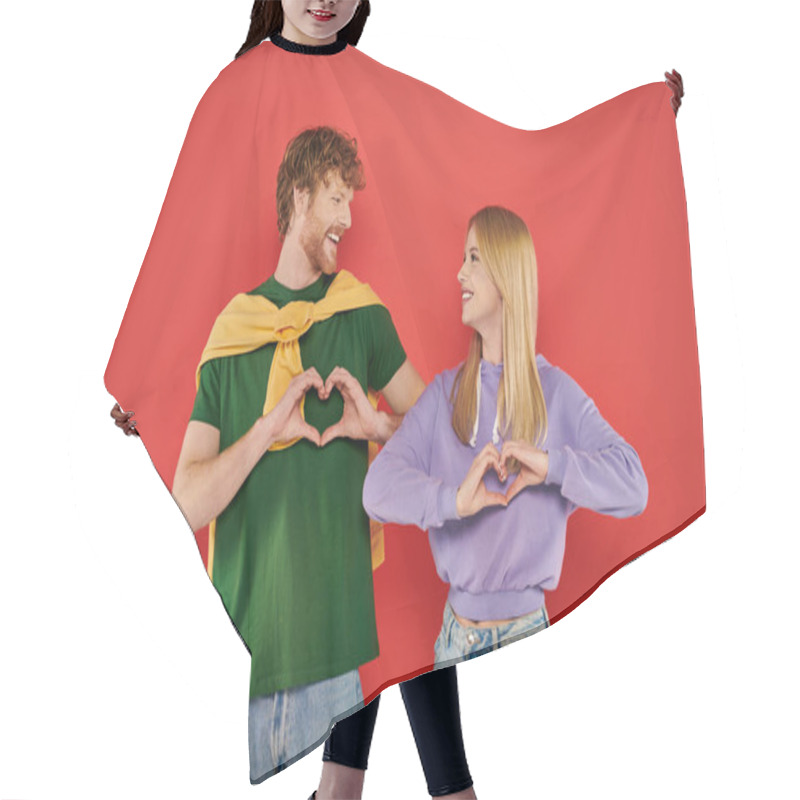 Personality  Young Couple Looking At Each Other On Coral Background, Showing Heart Sign With Hands Vibrant Colors, Stylish Outfits, Modern Family, Handsome Man And Beautiful Woman, Bonding And Love, Togetherness  Hair Cutting Cape