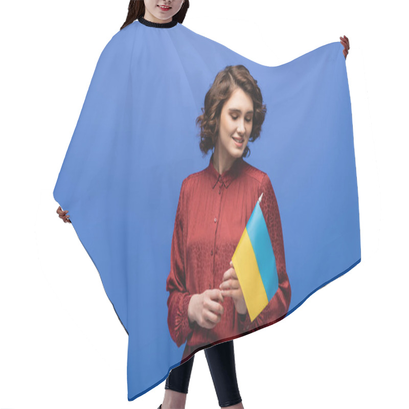 Personality  Joyful Language Teacher Holding Flag Of Ukraine And Smiling Isolated On Blue  Hair Cutting Cape